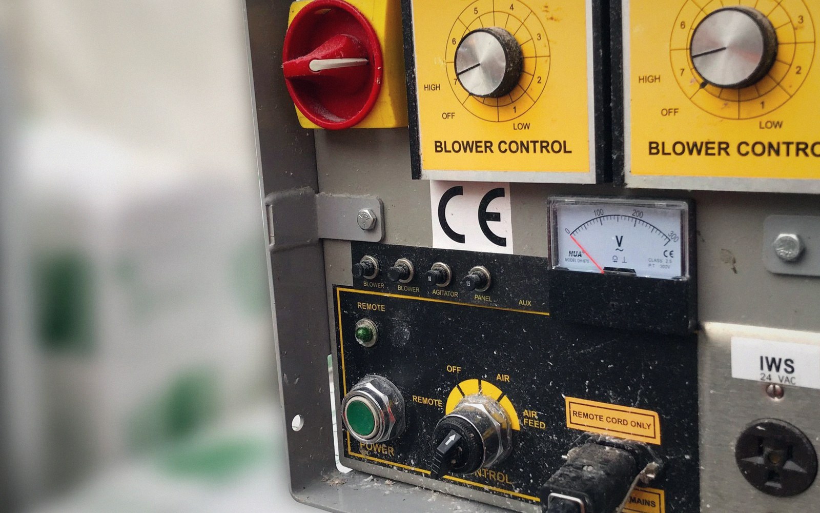 Control panel with blower control dials, a red switch, voltmeter, and green power button